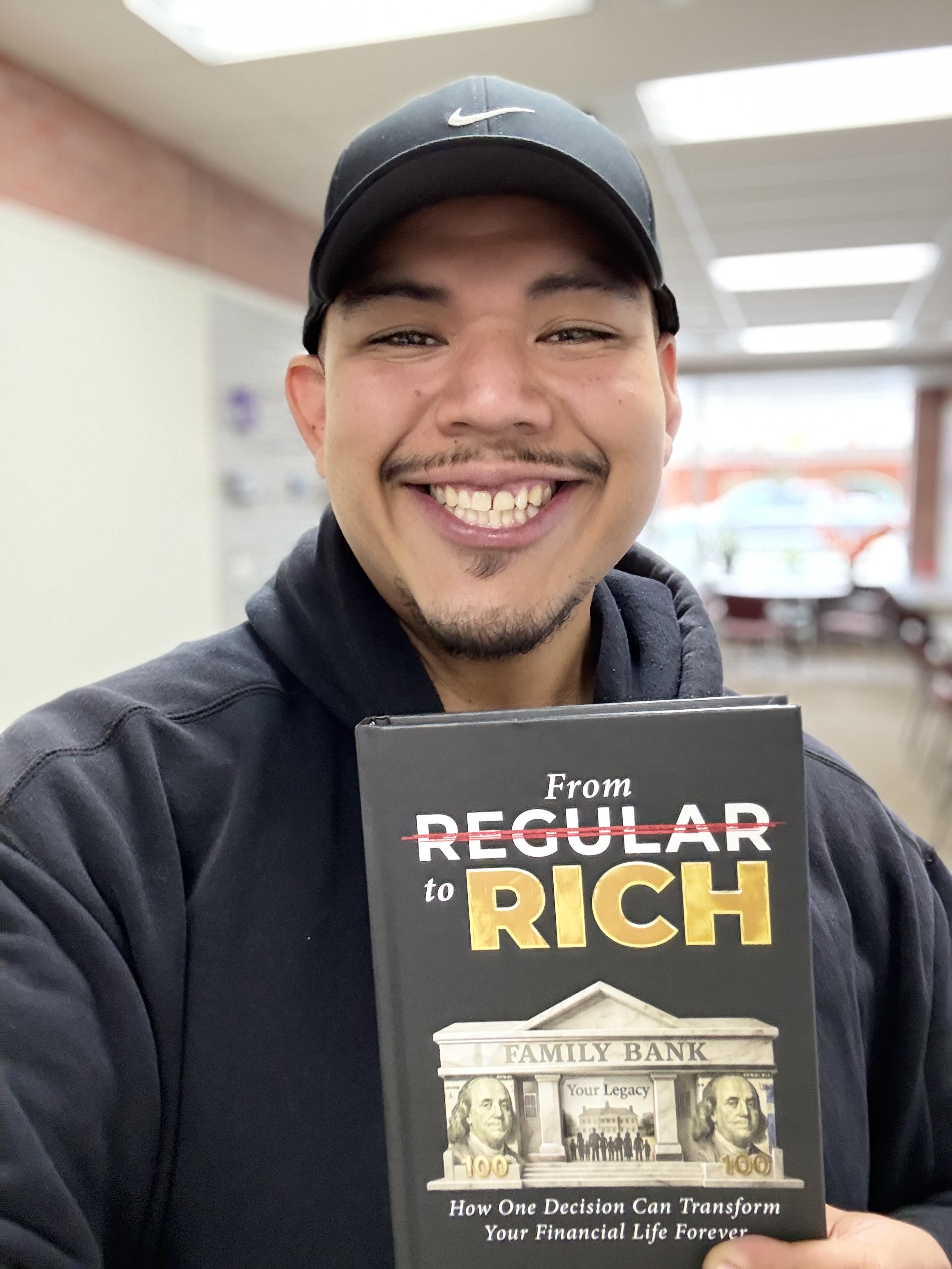 Reader holding a copy of From Regular to Rich by Shawn King.