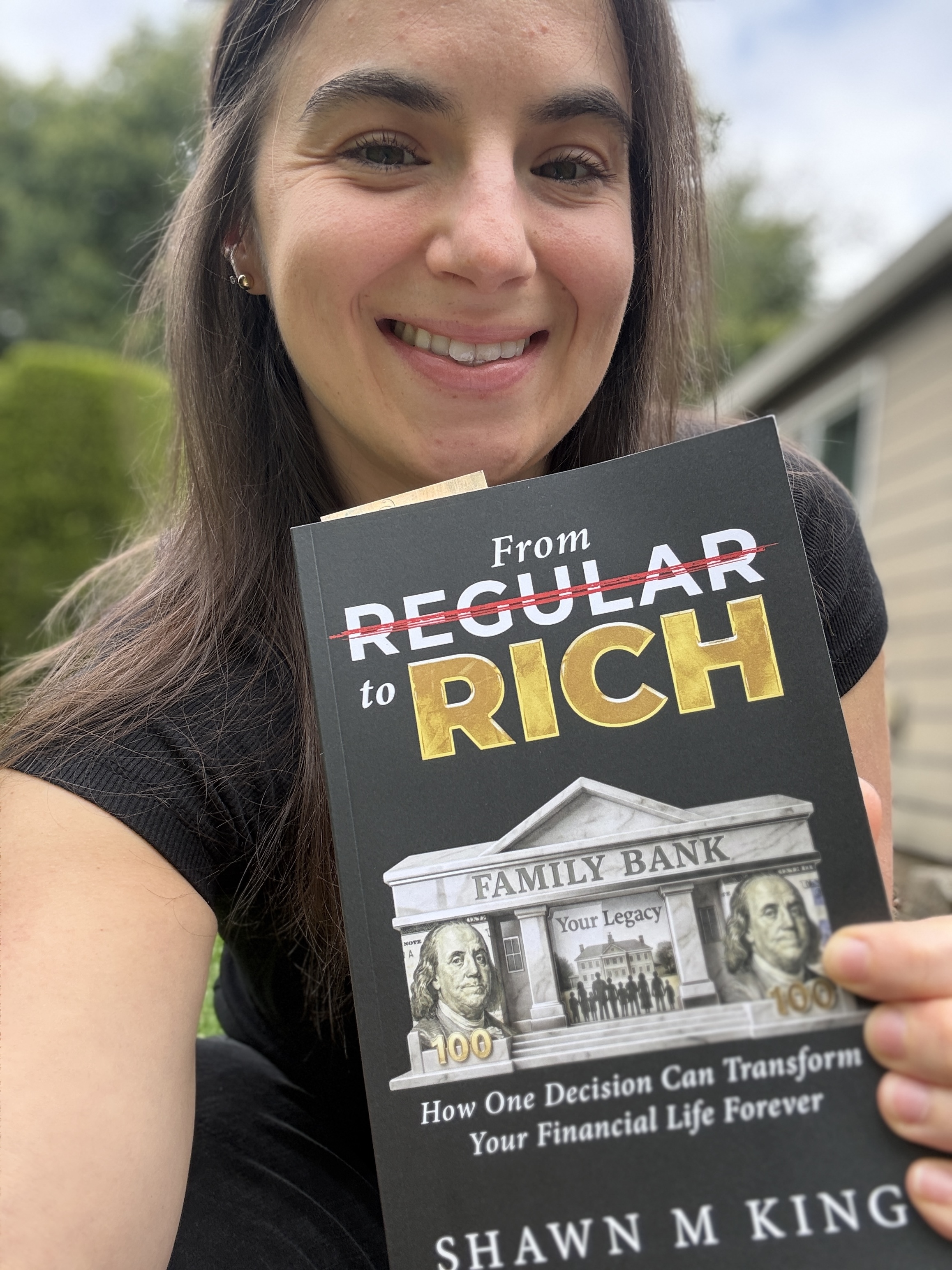 Reader holding a copy of From Regular to Rich by Shawn King.