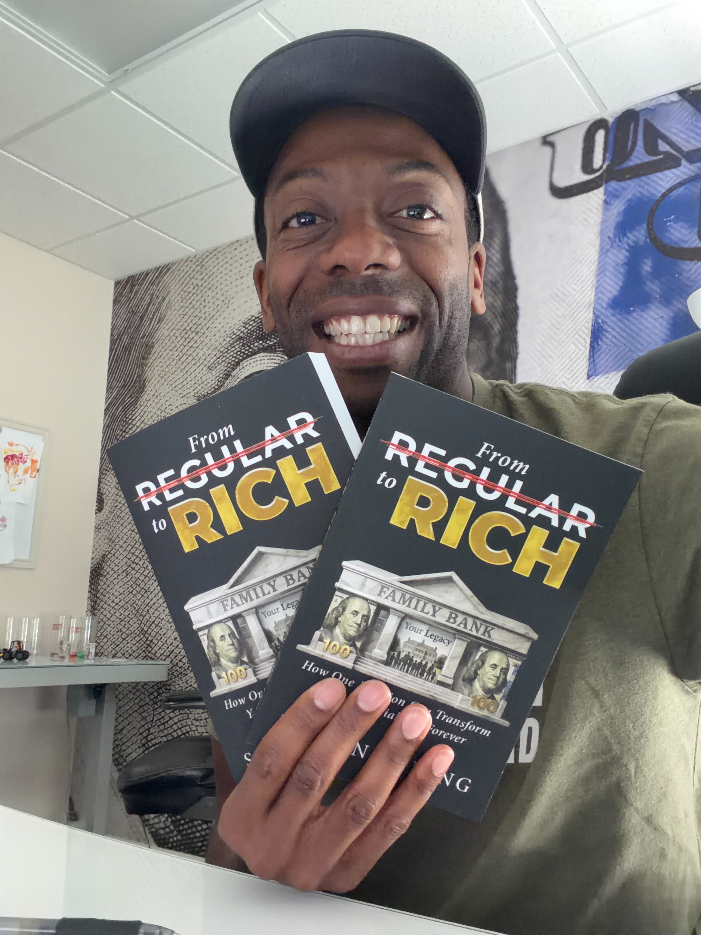 Reader holding two copies of From Regular to Rich by Shawn King.
