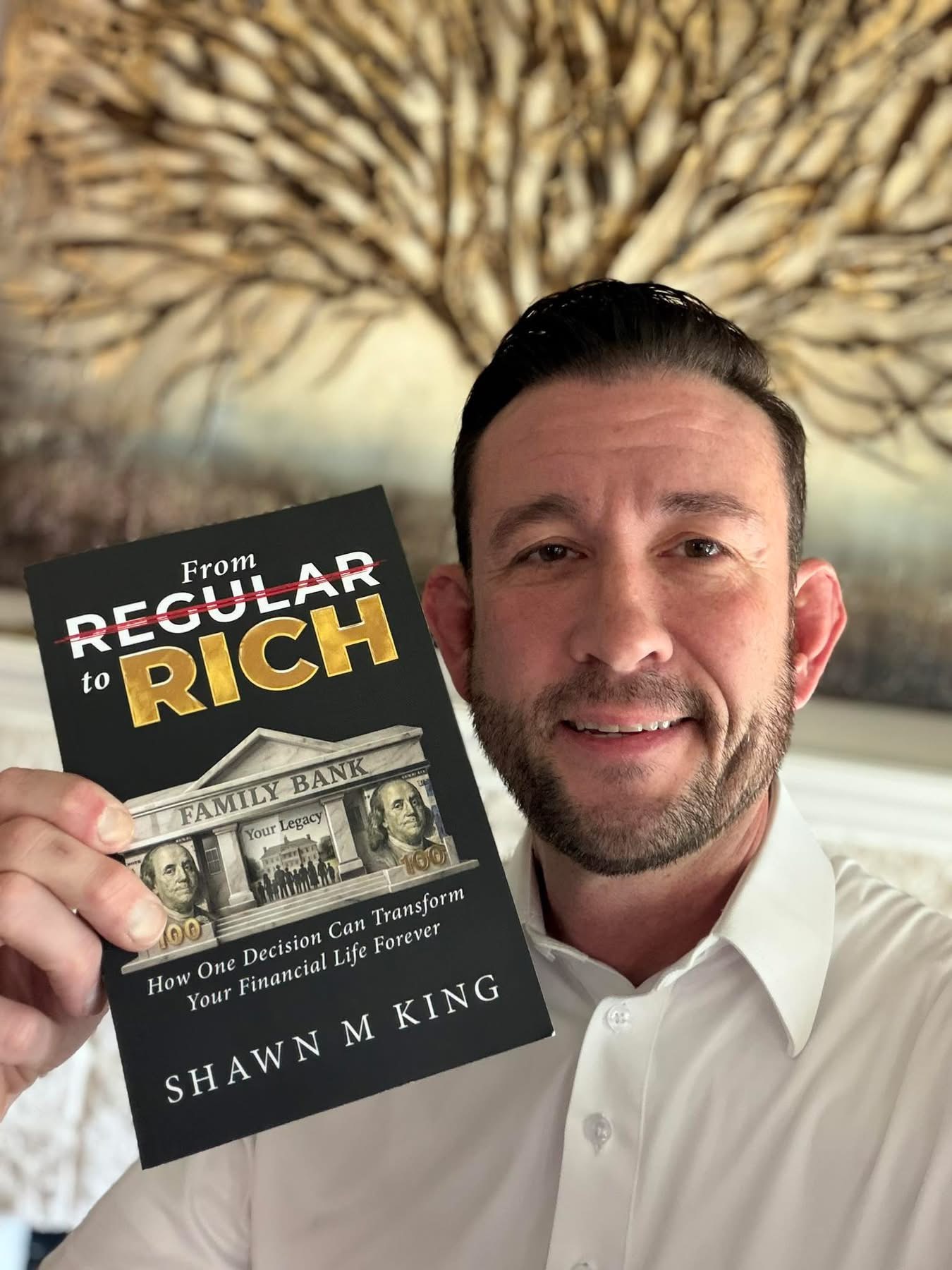Reader holding a copy of From Regular to Rich by Shawn King.